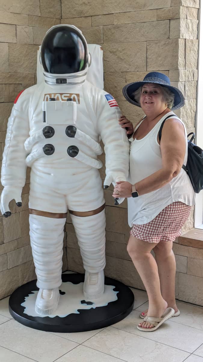 Morag pictured alongside a Spaceman statue in a hotel lobby