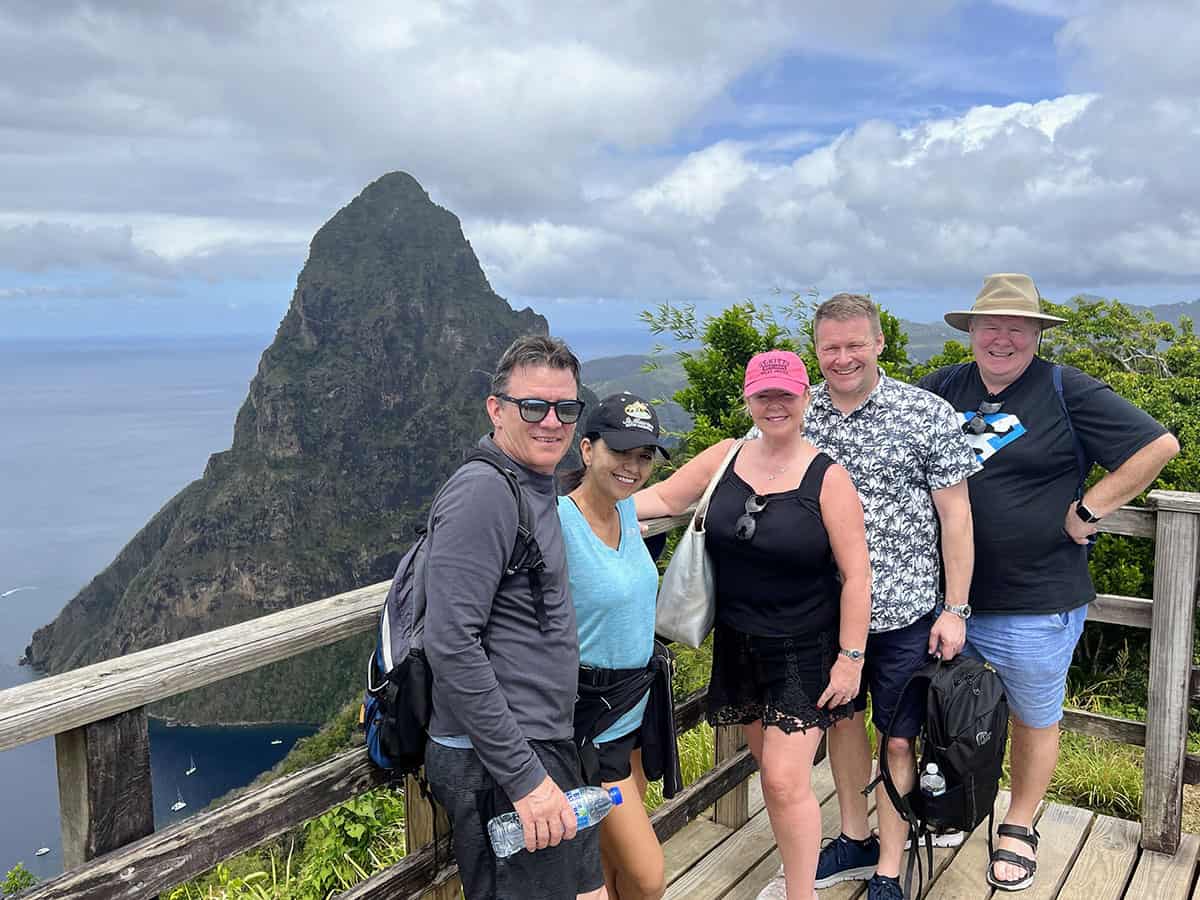 Friends posing for a photo with the Grand Piton of St Lucia in the background