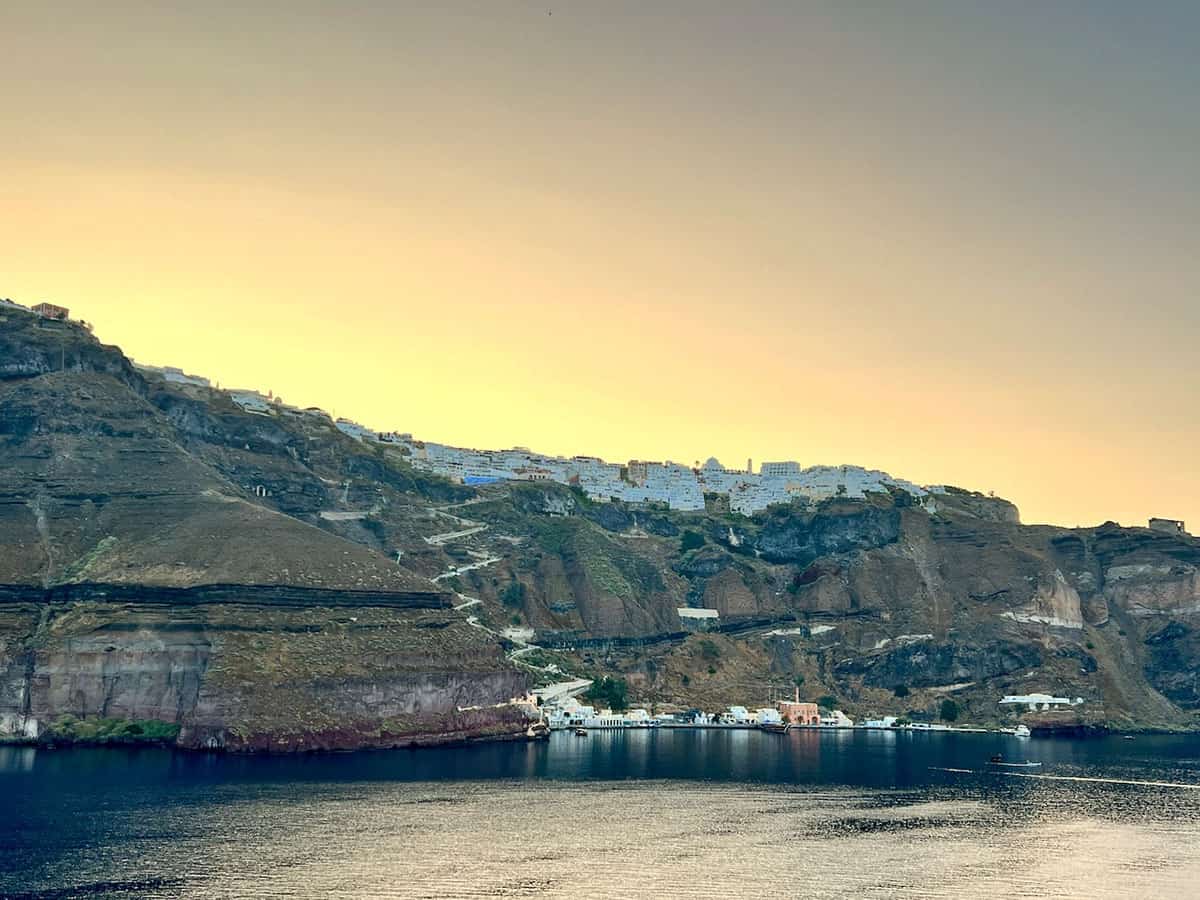 View of Santorini cruise port with the village of Fira perched at the top of the cliff