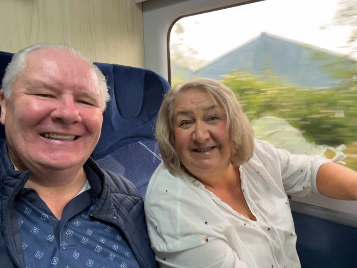 Alan and Morag Hutchison on a train journey to their cruise port