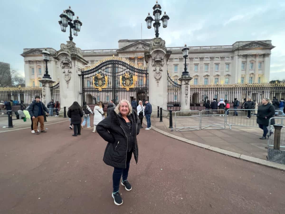 Morag Hutchison posing outside Buckingham Palace in London
